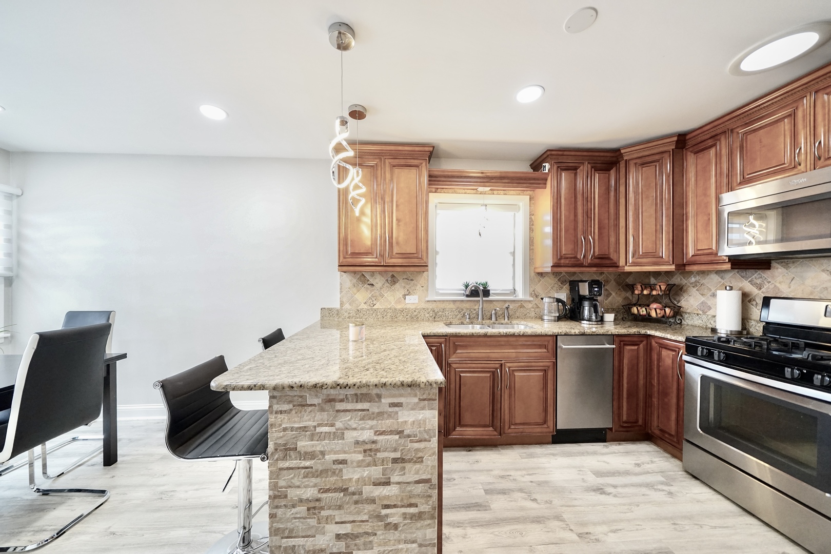 7122 Agatite Avenue Norridge, IL 60706 - Photo 20 of 64 a kitchen with stainless steel appliances granite countertop a sink and cabinets
