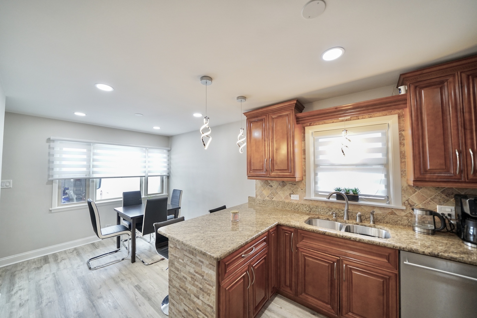 7122 Agatite Avenue Norridge, IL 60706 - Photo 29 of 64 a kitchen with stainless steel appliances granite countertop sink microwave and window