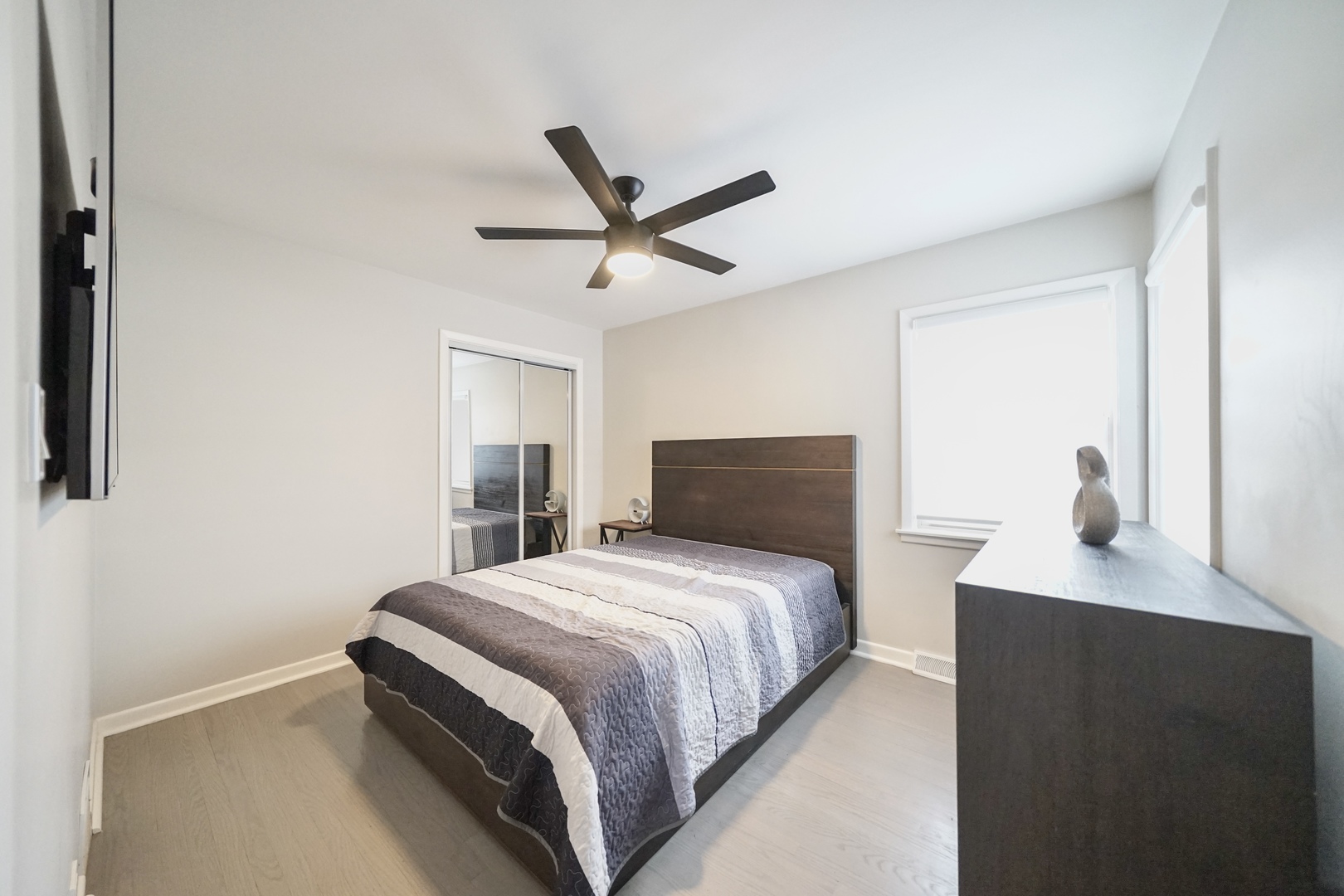 7122 Agatite Avenue Norridge, IL 60706 - Photo 31 of 64 a bedroom with a bed and a chandelier