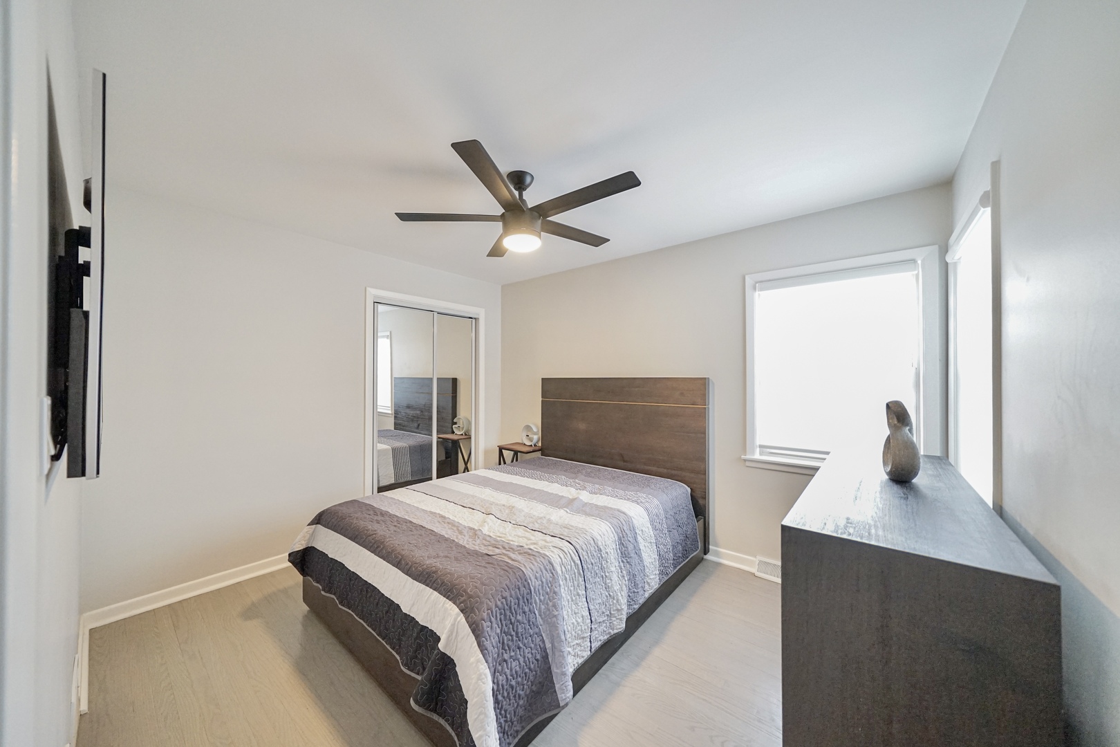 7122 Agatite Avenue Norridge, IL 60706 - Photo 33 of 64 a bedroom with a large bed and a chandelier