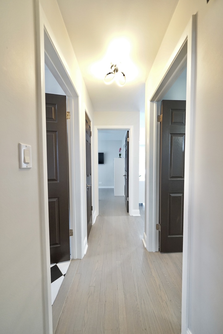 7122 Agatite Avenue Norridge, IL 60706 - Photo 41 of 64 a view of a hallway with wooden shelves