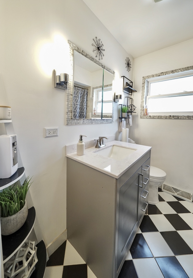 7122 Agatite Avenue Norridge, IL 60706 - Photo 44 of 64 a bathroom with a sink toilet and mirror