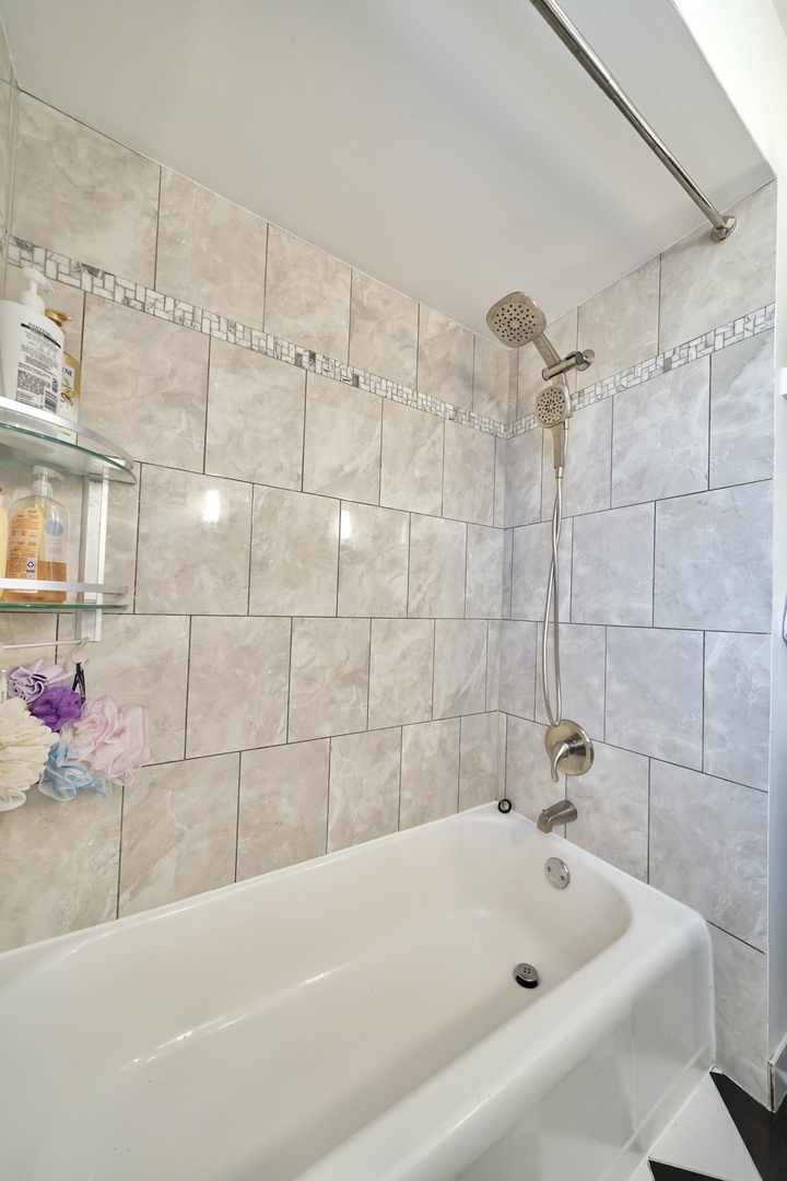 7122 Agatite Avenue Norridge, IL 60706 - Photo 45 of 64 a bathroom with a bathtub and shower