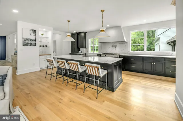 a kitchen with a table chairs refrigerator and window