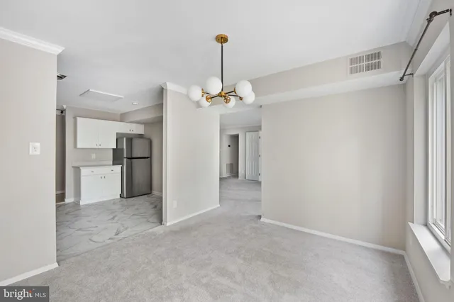 a view of a kitchen with a refrigerator and a sink