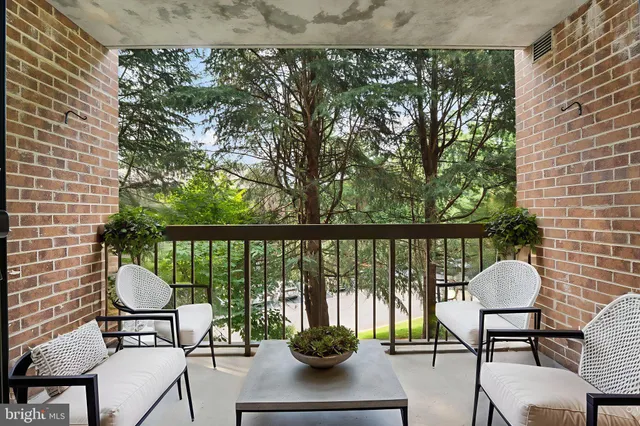 a front view of a house with a yard and garden