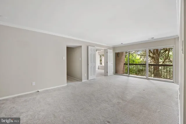 a view of an empty room with a large window