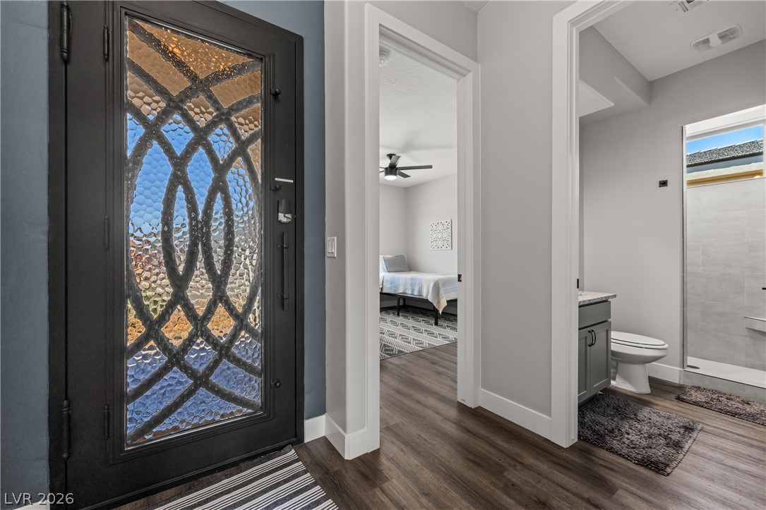 1436 Manassas Ridge Mesquite, NV 89027 - Photo 4 of 77 A decorative glass entry door welcomes you to a residence featuring modern flooring and bright interior spaces.