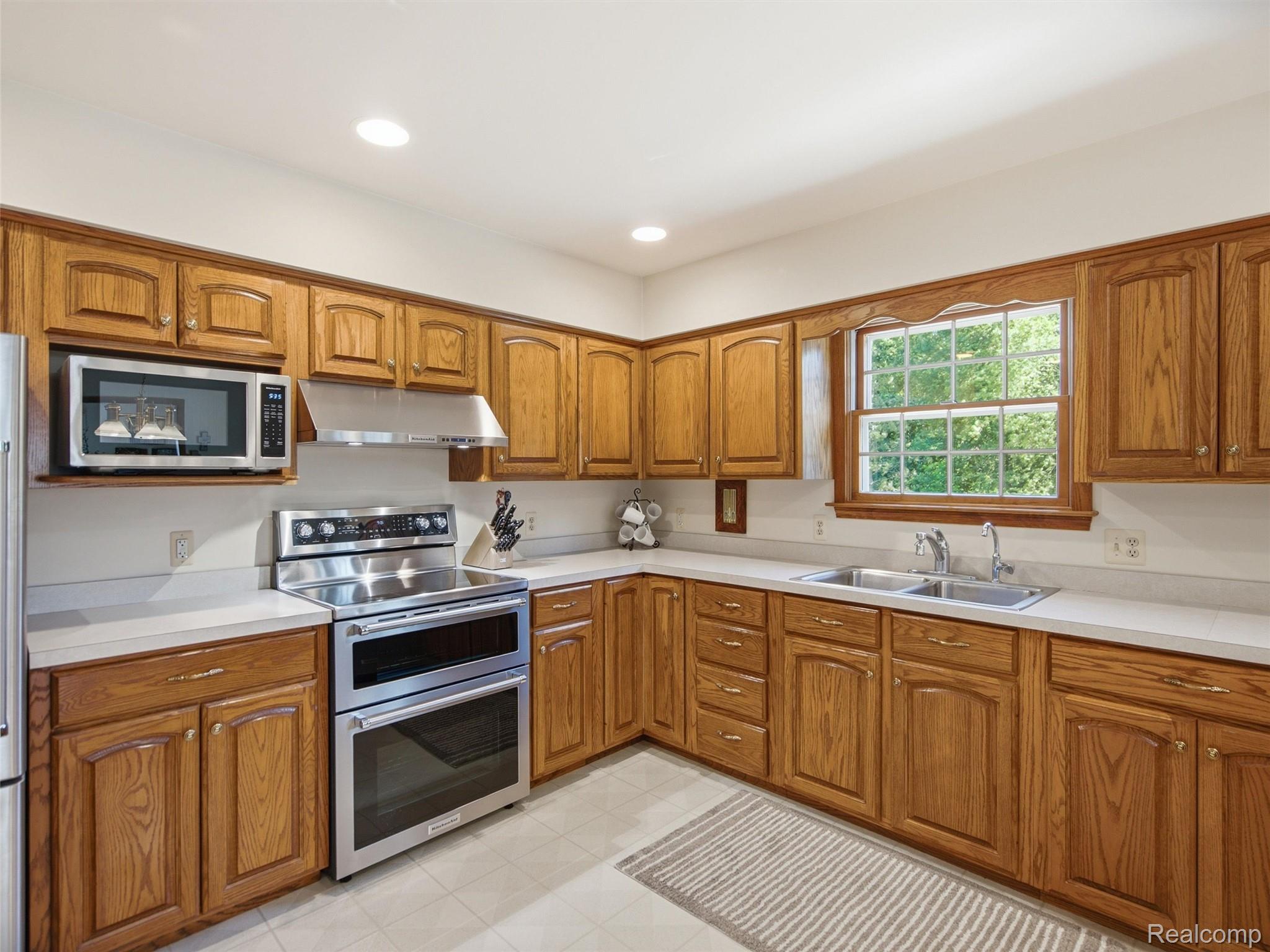 5449 Lum Road Attica, MI 48412 - Photo 36 of 82 Kitchen featuring wood-finish cabinetry, light countertops, and a dual basin stainless steel sink