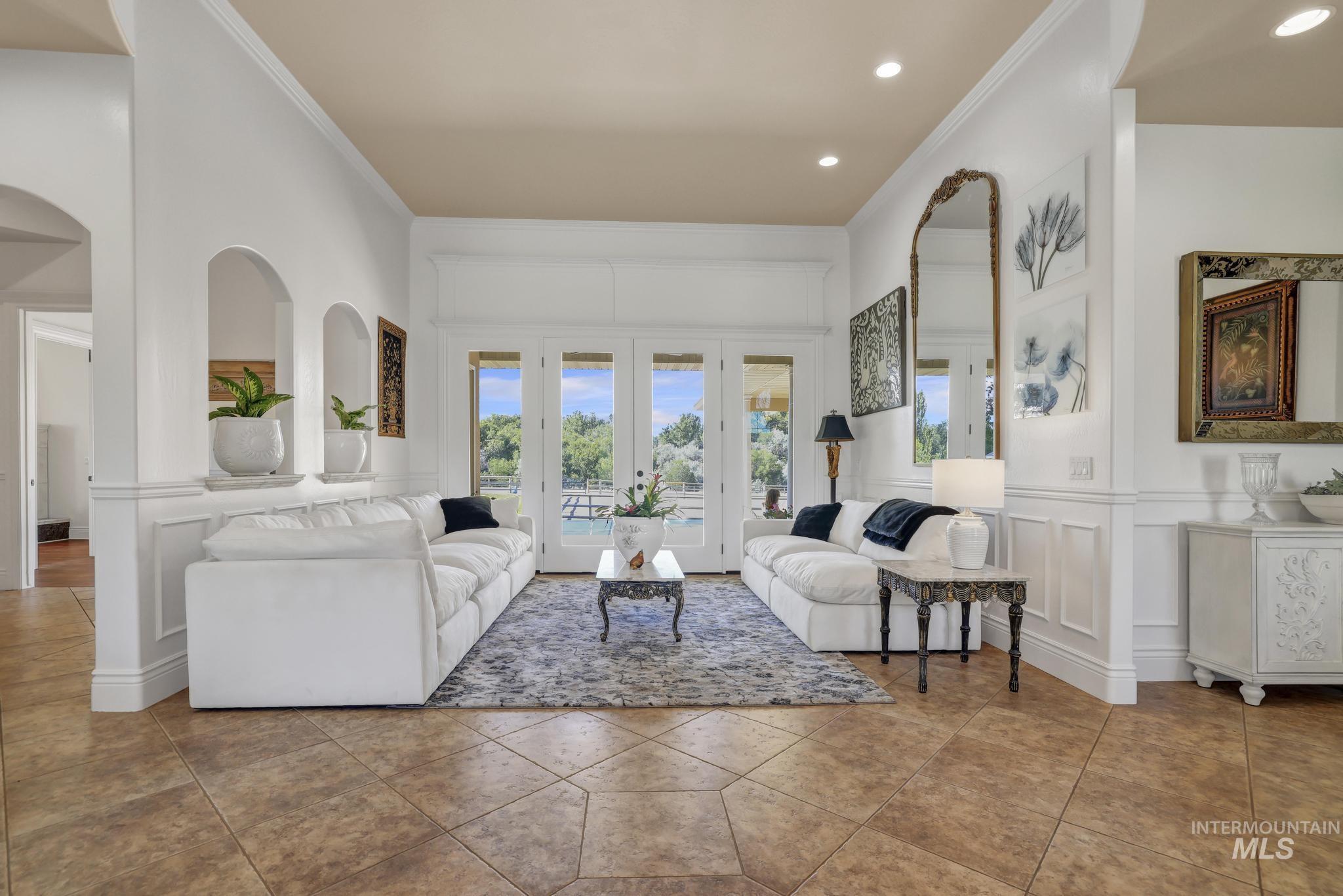 1301 Kanaka Rapids Road Buhl, ID 83316 - Photo 7 of 50 Spacious living area featuring multi-pane glass doors, recessed lighting, and wainscoting
