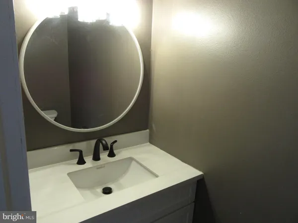 a bathroom with a sink and mirror