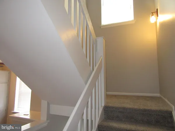 a view of staircase with wooden floor and door