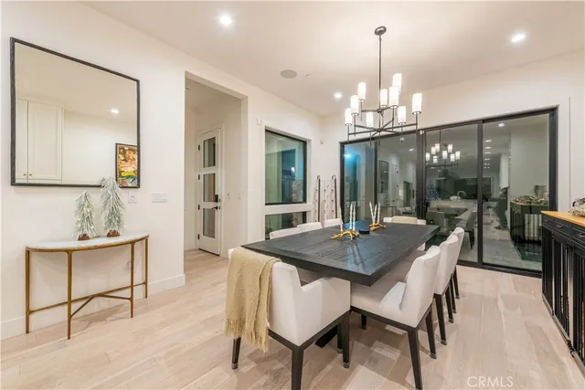 a view of a dining room with furniture wooden floor and chandelier