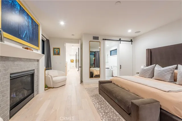 a spacious bedroom with a large bed and a fireplace