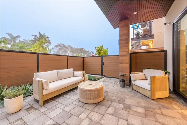 a outdoor living room with furniture and a potted plant