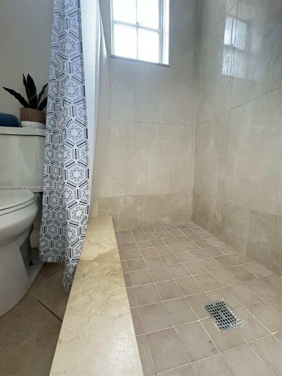 12833 Southwest 146th Terrace Miami, FL 33186 - Photo 18 of 29 a bathroom with a toilet and a shower