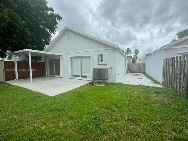 a backyard of a house with table and chairs