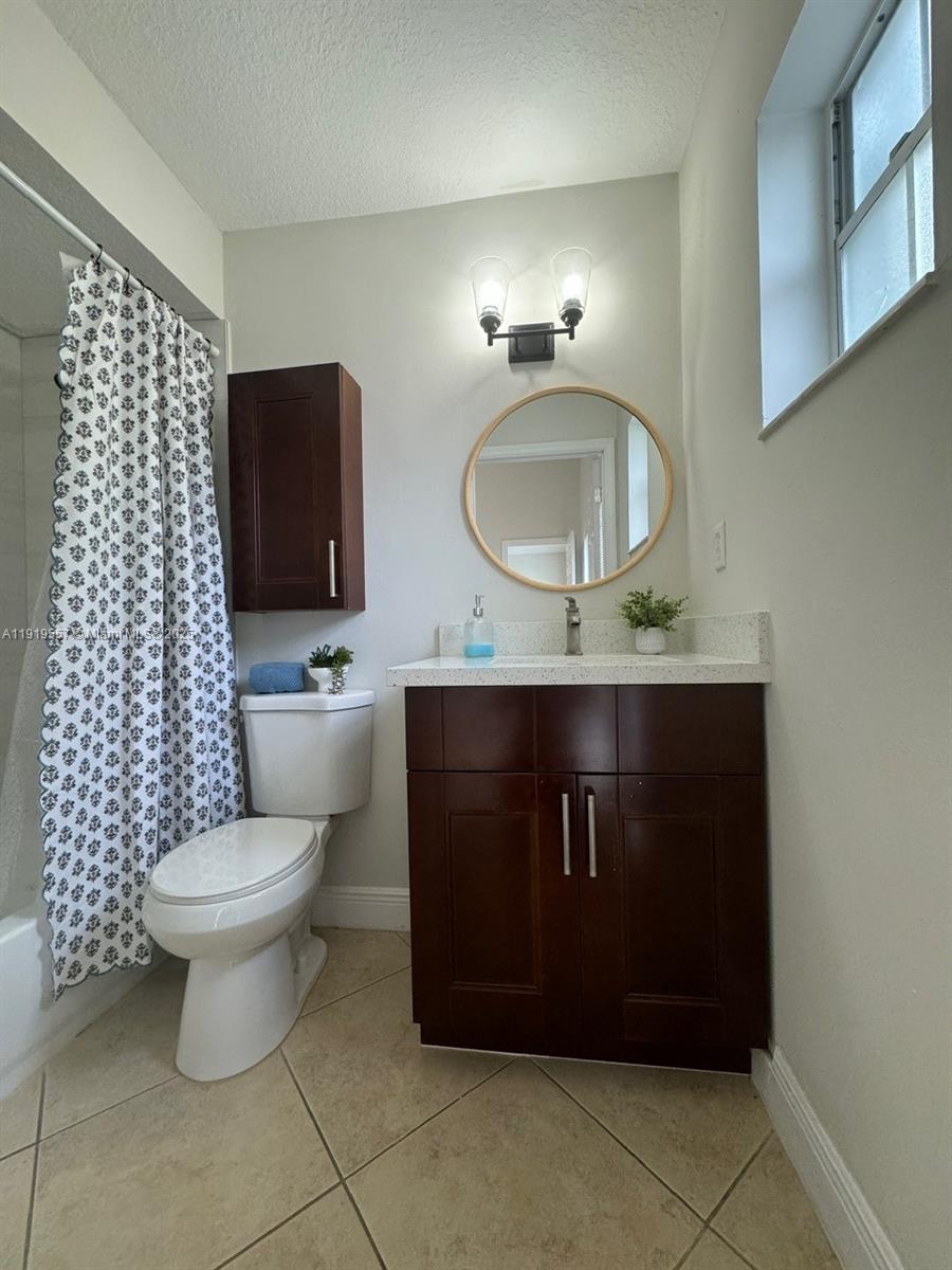 12833 Southwest 146th Terrace Miami, FL 33186 - Photo 8 of 29 a bathroom with a toilet a sink and mirror