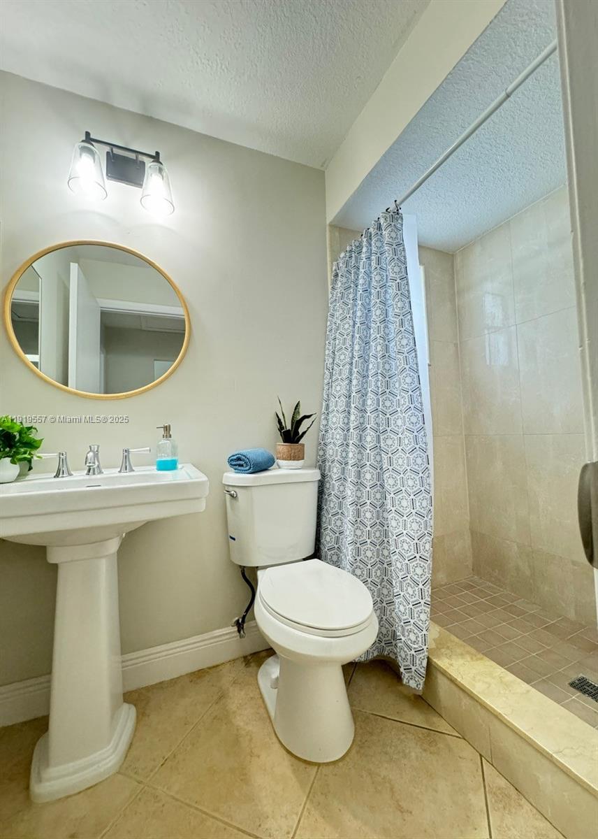 12833 Southwest 146th Terrace Miami, FL 33186 - Photo 9 of 29 a bathroom with a sink toilet and shower