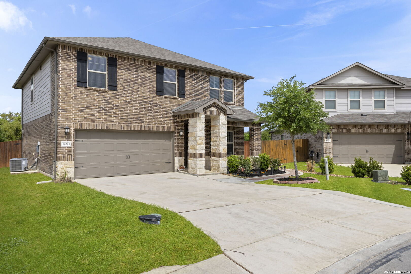 12221 Icon Ridge San Antonio, TX 78253 - Photo 3 of 46 a front view of a house with a yard and garage