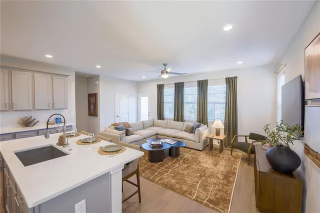 a kitchen with stainless steel appliances a table chairs and refrigerator