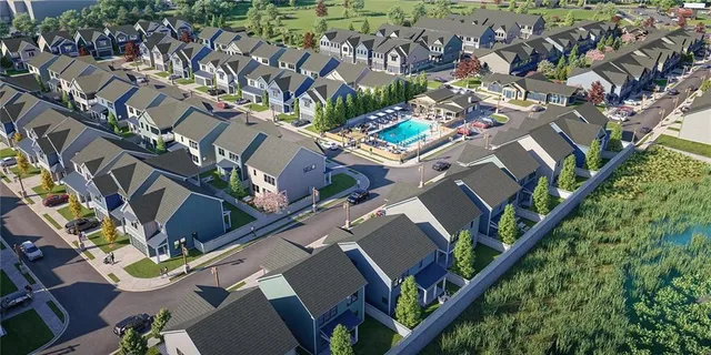 an aerial view of a house with a yard and large trees