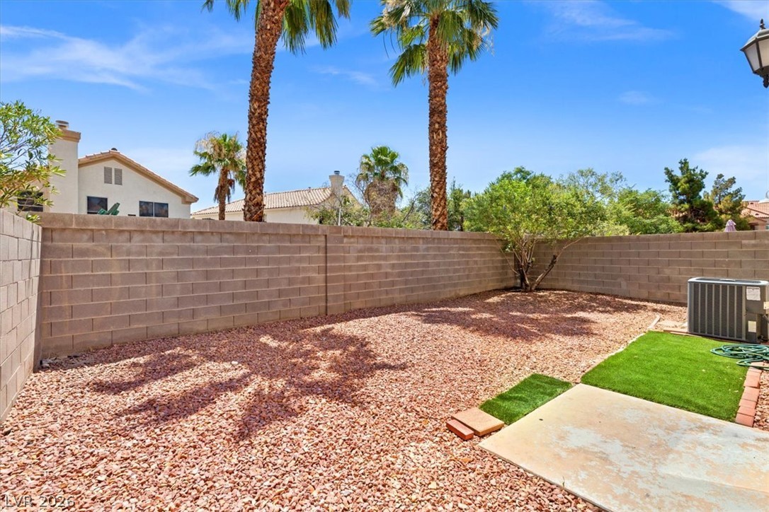 1412 Beaver Spring Street Las Vegas, NV 89128 - Photo 17 of 20 A private, low-maintenance yard offers both stone and artificial turf areas, perfect for relaxation.