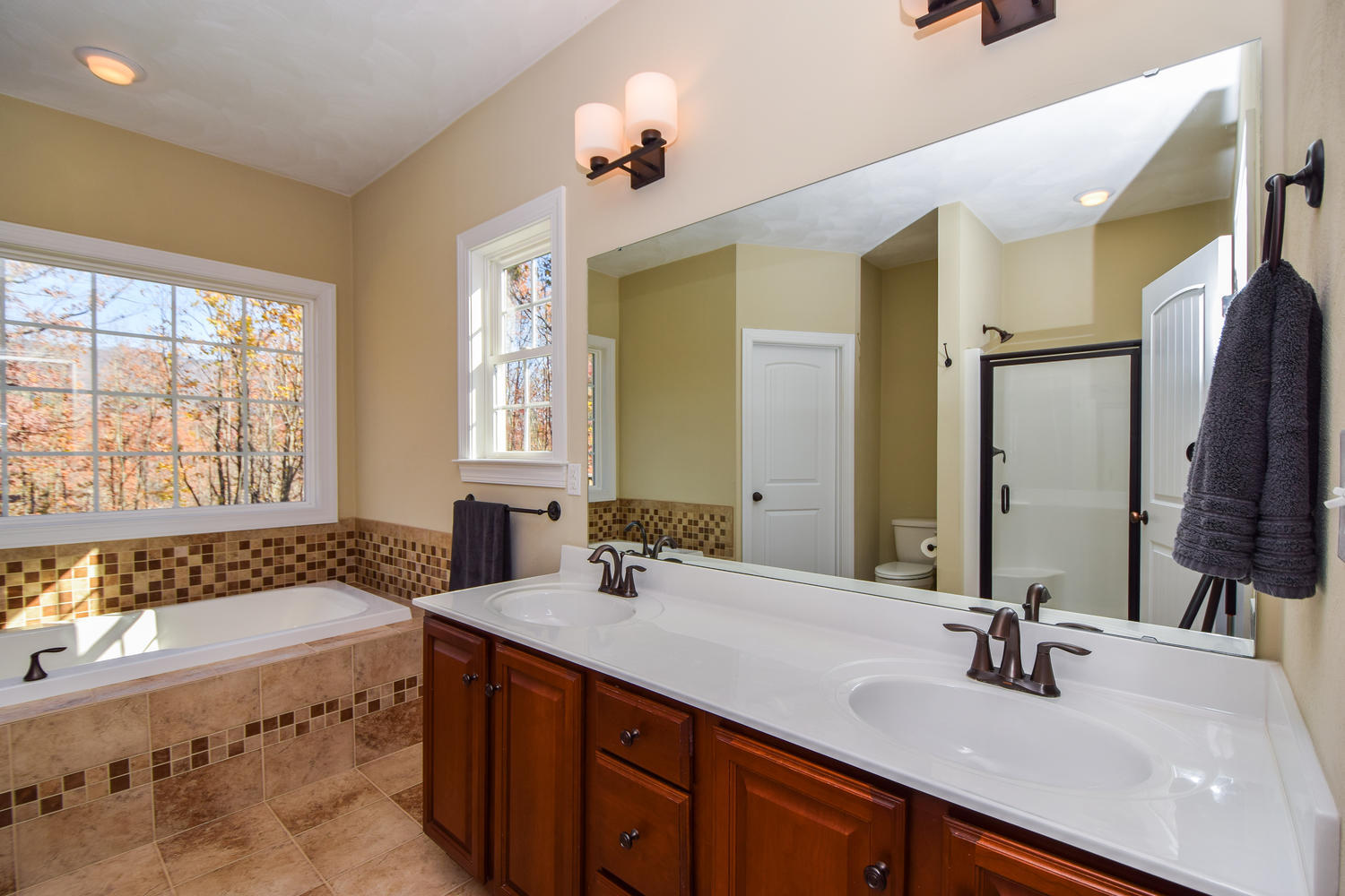 45 Turtle Rock Ridge Blue Ridge, VA 24064 - Photo 26 of 55 a bathroom with a double vanity sink large mirror and a bathtub