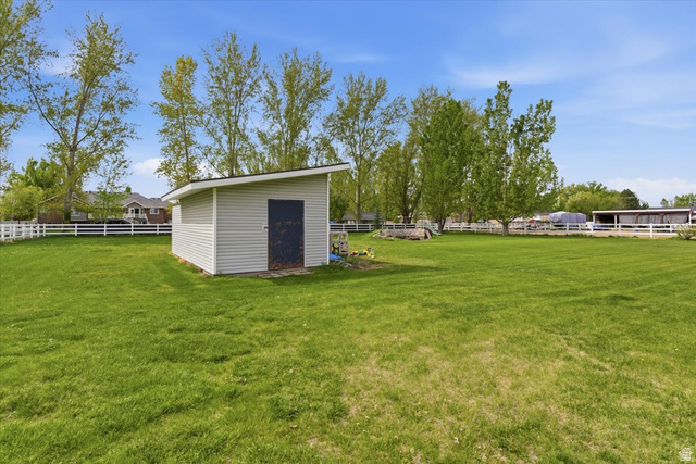 6237 West 4600th Street South Hooper, UT 84315 - Photo 43 of 48 Fenced backyard with a storage unit