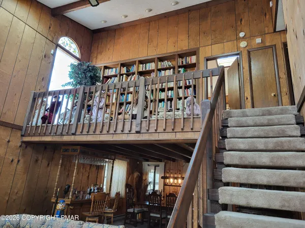 a view of a room with lots of wooden furniture