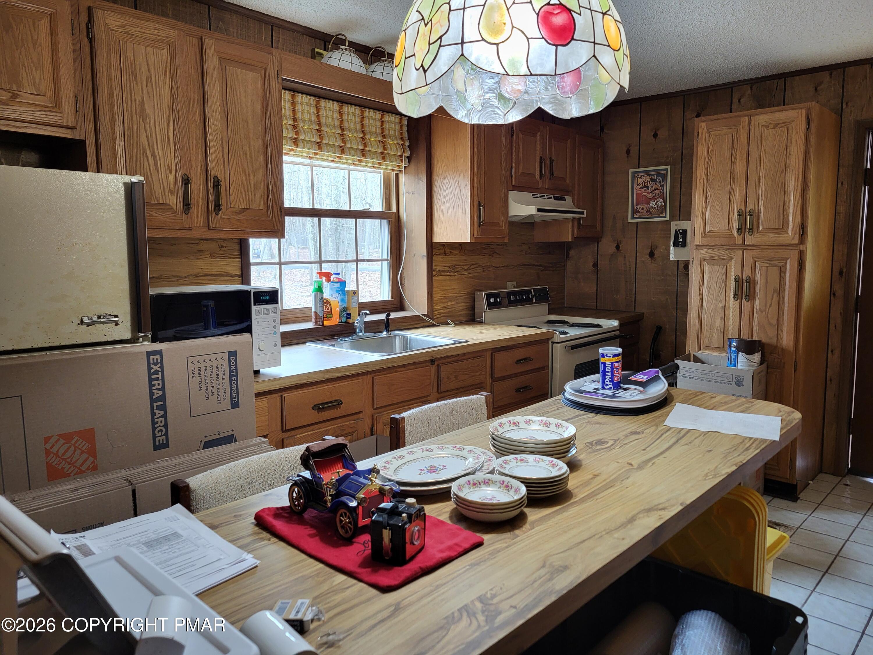 2014 Scarborough Way Bushkill, PA 18324 - Photo 46 of 82 a view of a dining room with furniture a kitchen and chandelier