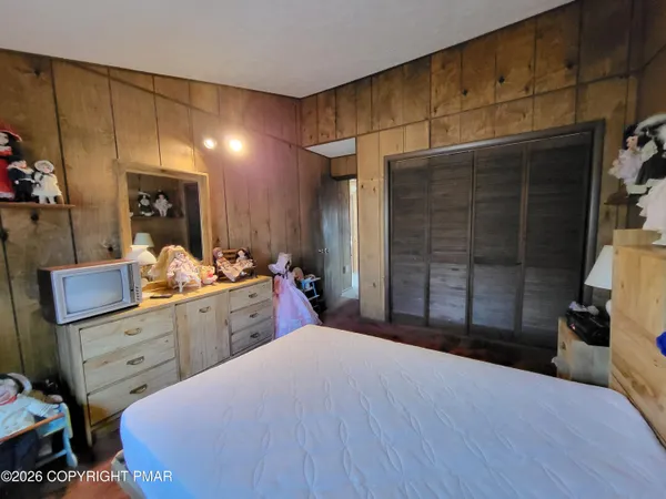 a bedroom with a bed and a flat screen tv