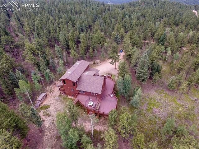 100 Hitchrack Road Bailey, CO 80421 - Photo 3 of 4 Aerial photo from back of home looking towards gently sloping driveway to Hitchrack Road, which is maintained by Park County.