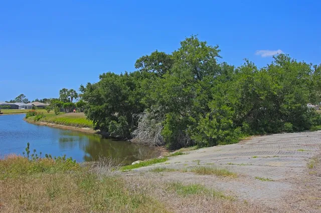a view of a lake with a house in the background