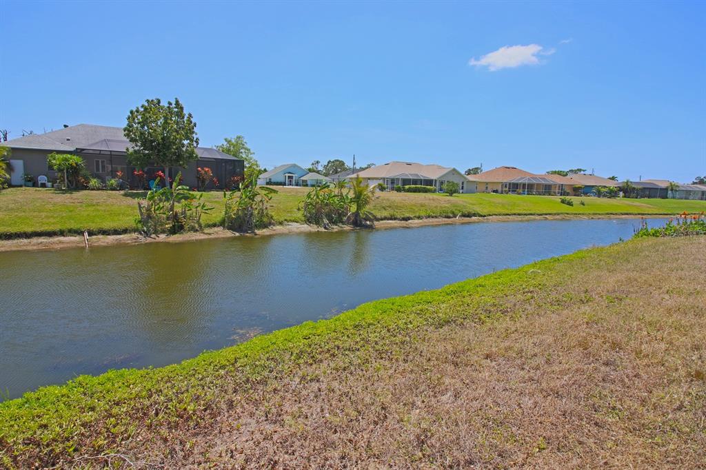 133 Fairway Road Rotonda West, FL 33947 - Photo 14 of 16 a view of a lake with houses in the back