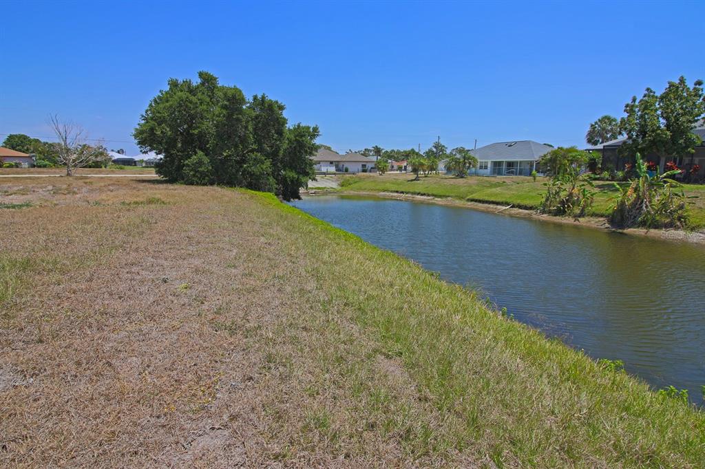 133 Fairway Road Rotonda West, FL 33947 - Photo 15 of 16 a view of a lake with houses in the background