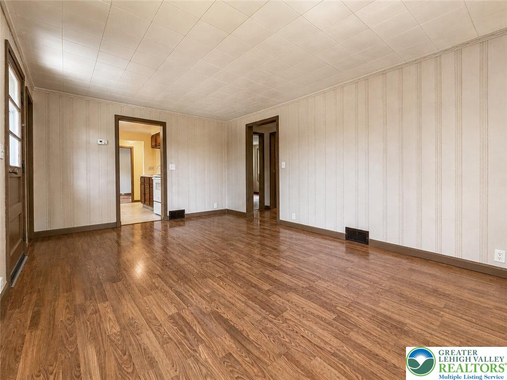 4995 Mountain Road Slatington, PA 18080 - Photo 7 of 30 Rich hardwood-style flooring extends across this spacious living area, leading to adjoining rooms.