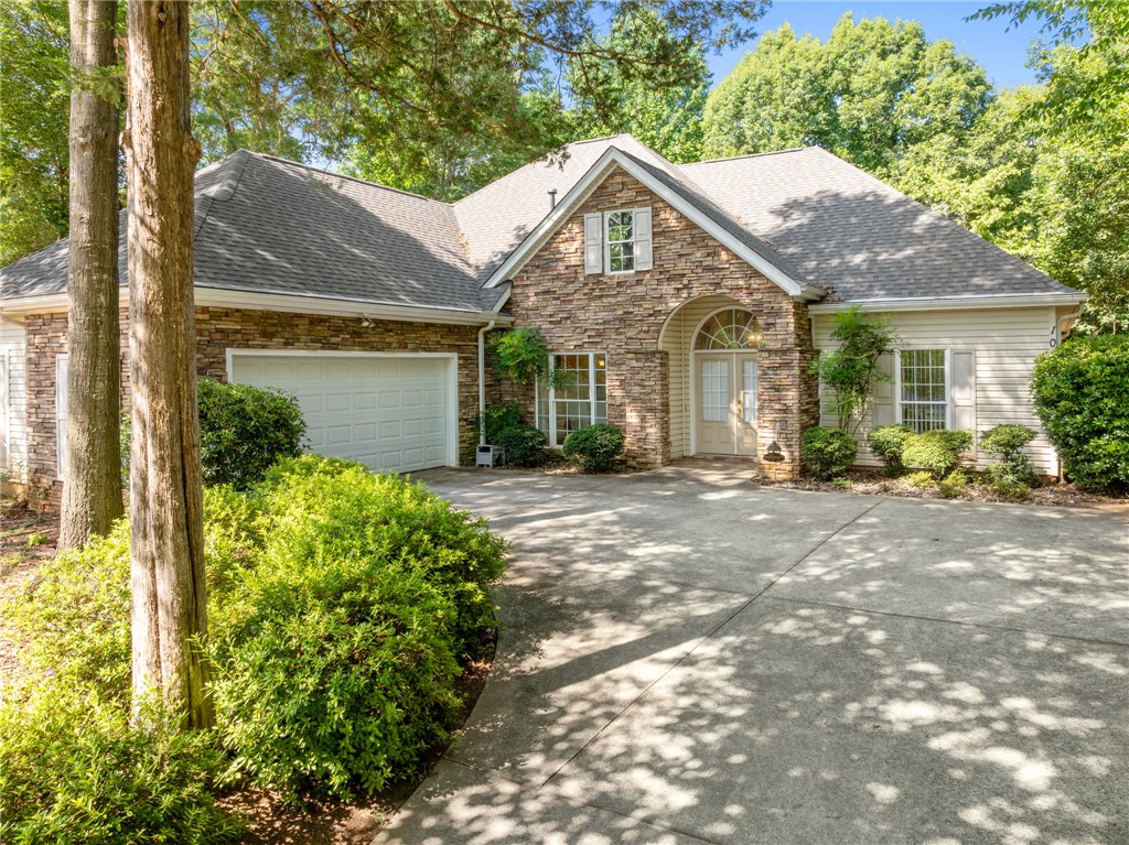 108 Winterbrook Circle Seneca, SC 29678 - Photo 1 of 40 A welcoming stone and siding facade with an integrated garage and manicured landscaping.