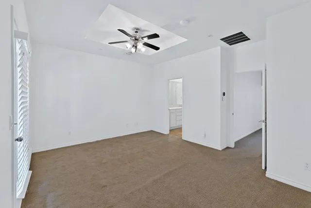 a view of an empty room with a fan