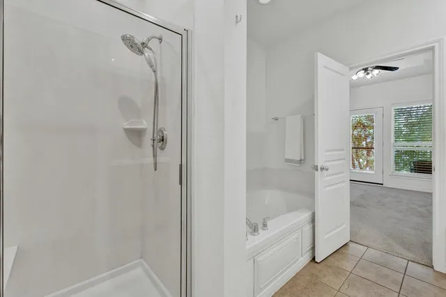 a bathroom with a bathtub and shower