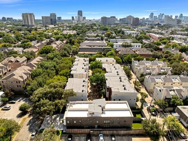 an aerial view of residential houses with city view