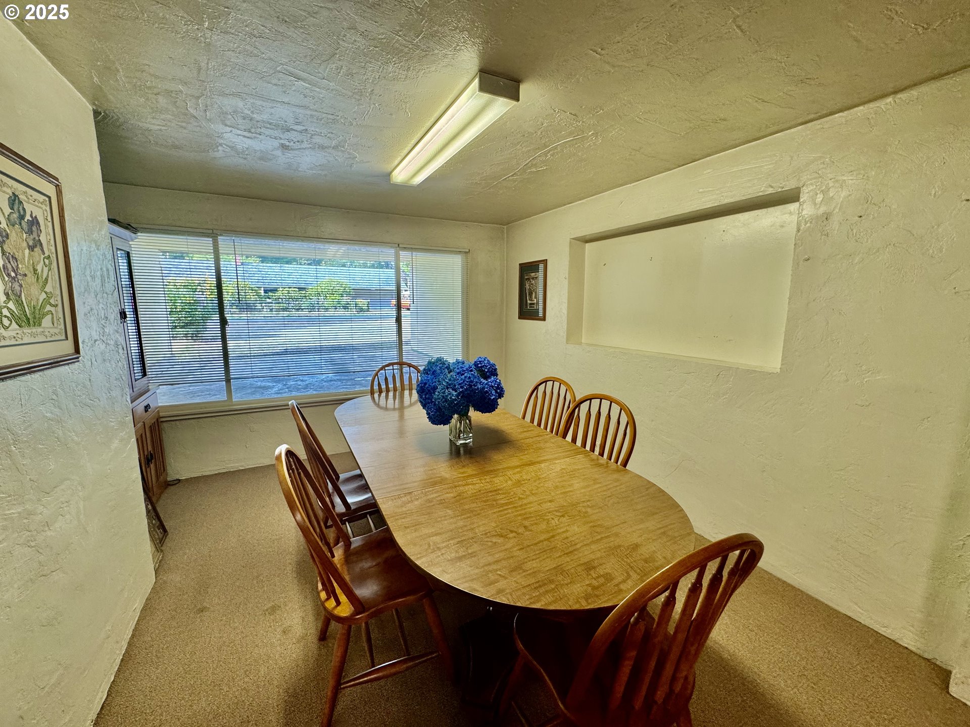4990 Mitchell Loop Road Florence, OR 97439 - Photo 13 of 37 a view of a dining room with furniture and a potted plant