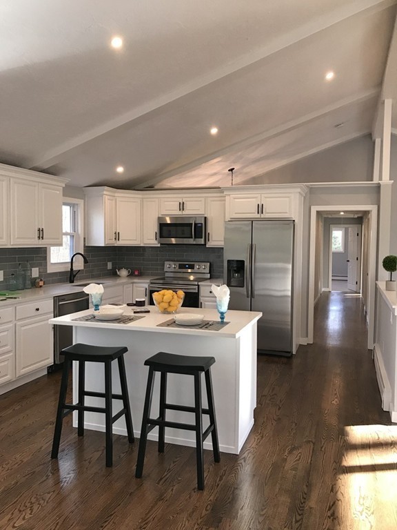 41 Ann Lees Road Harvard, MA 01451 - Photo 7 of 22 a kitchen with a table chairs refrigerator and microwave