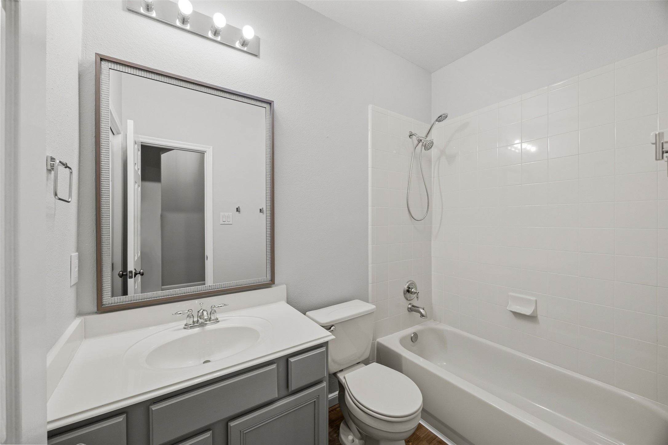 12322 West Elizabeth Shore Loop Cypress, TX 77433 - Photo 19 of 28 a bathroom with a granite countertop sink a toilet and shower