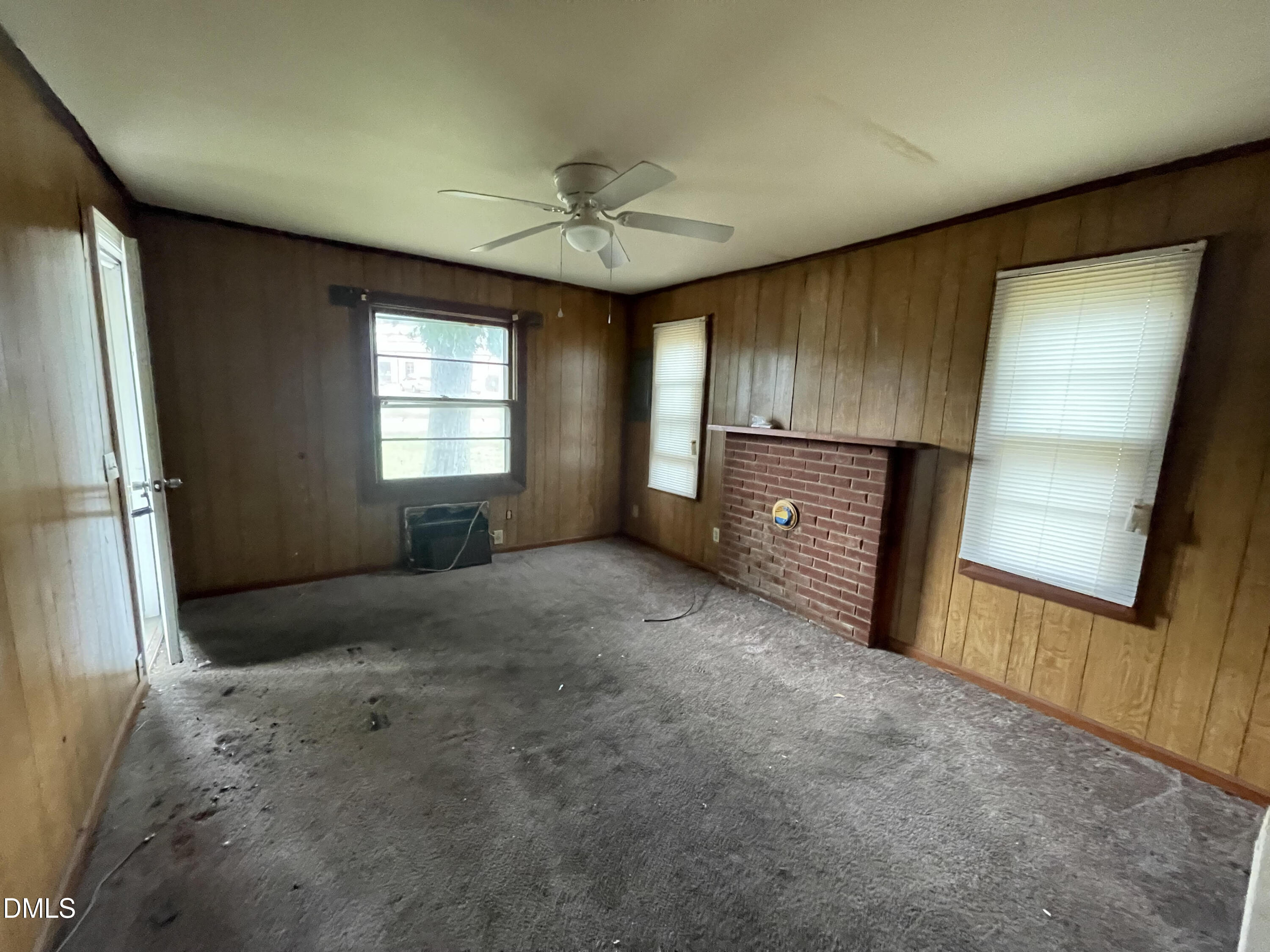 1023 Leasburg Road Roxboro, NC 27573 - Photo 4 of 12 a view of an empty room with a fireplace and a window
