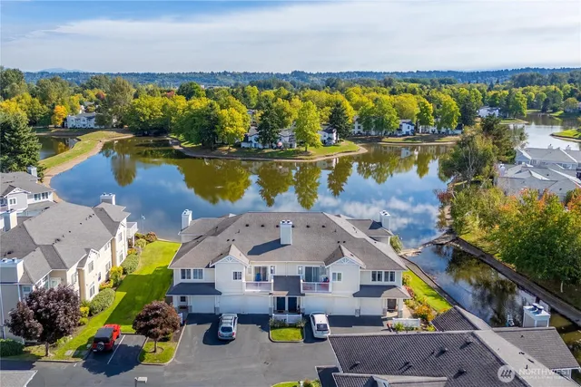 an aerial view of a house with a swimming pool patio and lake view