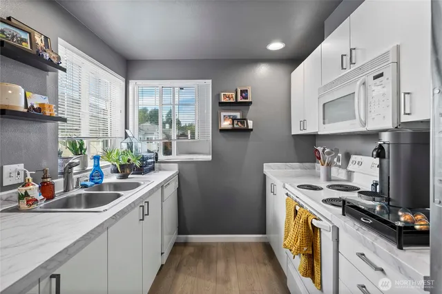 a kitchen with a sink stove and cabinets