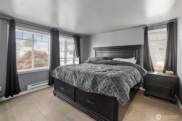 a bed sitting in a bedroom next to a window