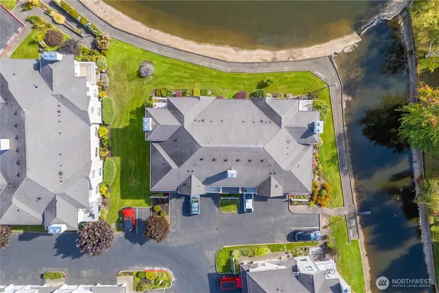 an aerial view of lake and residential houses with outdoor space