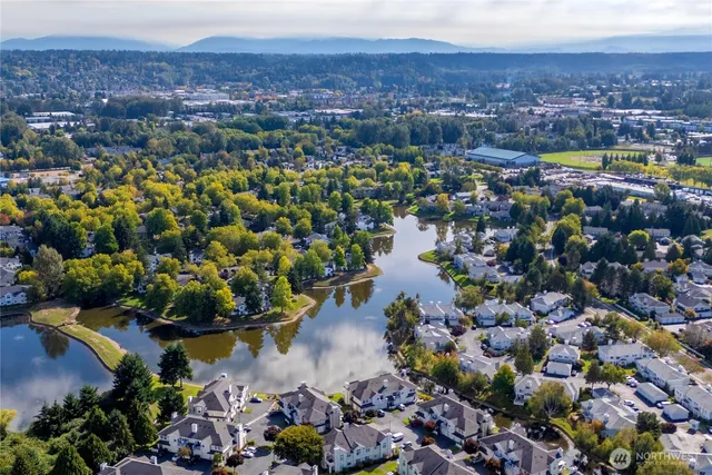 a view of a lake with houses in the back